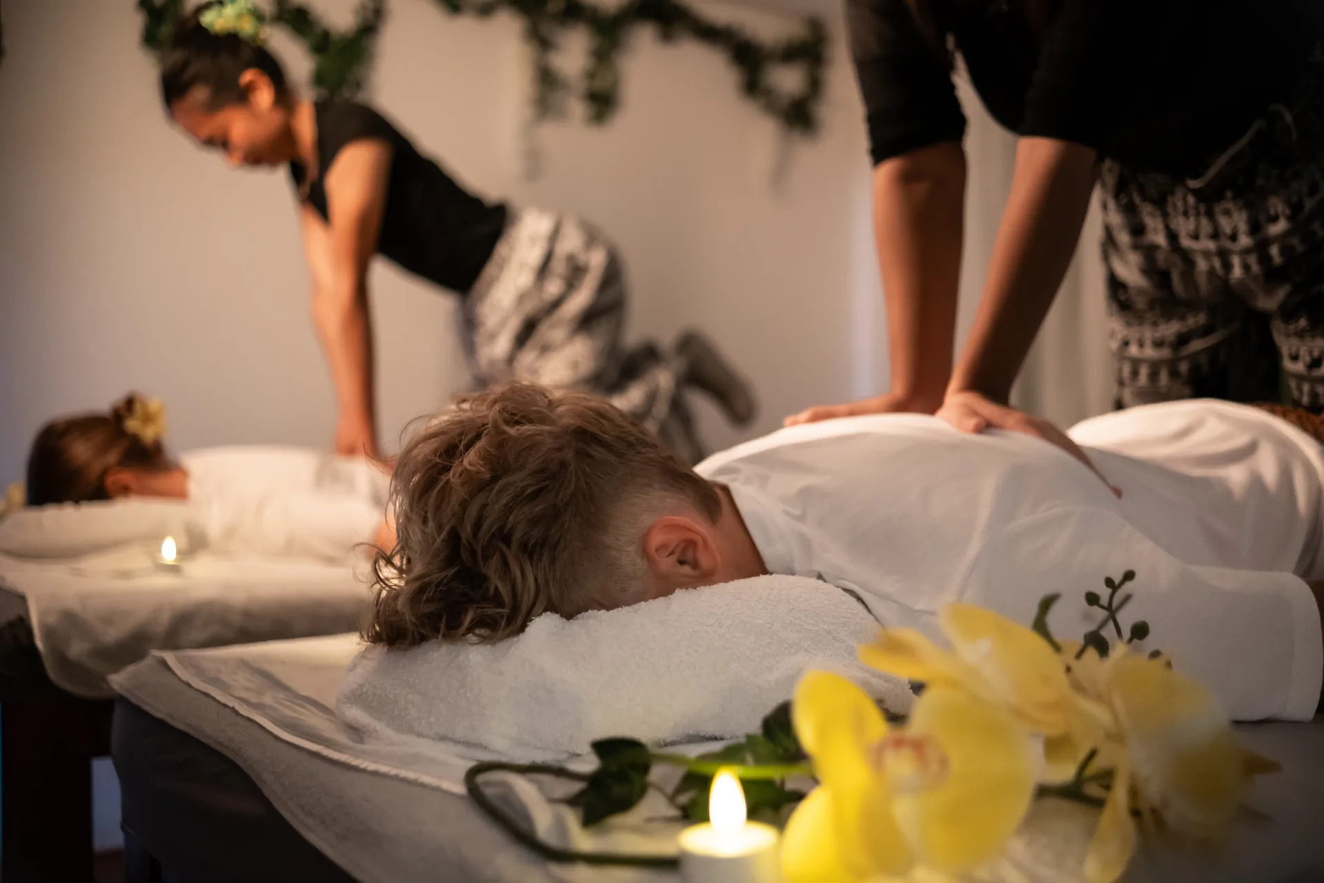 Two therapists providing a synchronized Thai massage